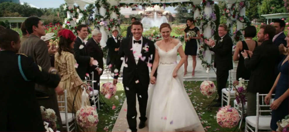 Booth and Brennan walk down the aisle as husband and wife.