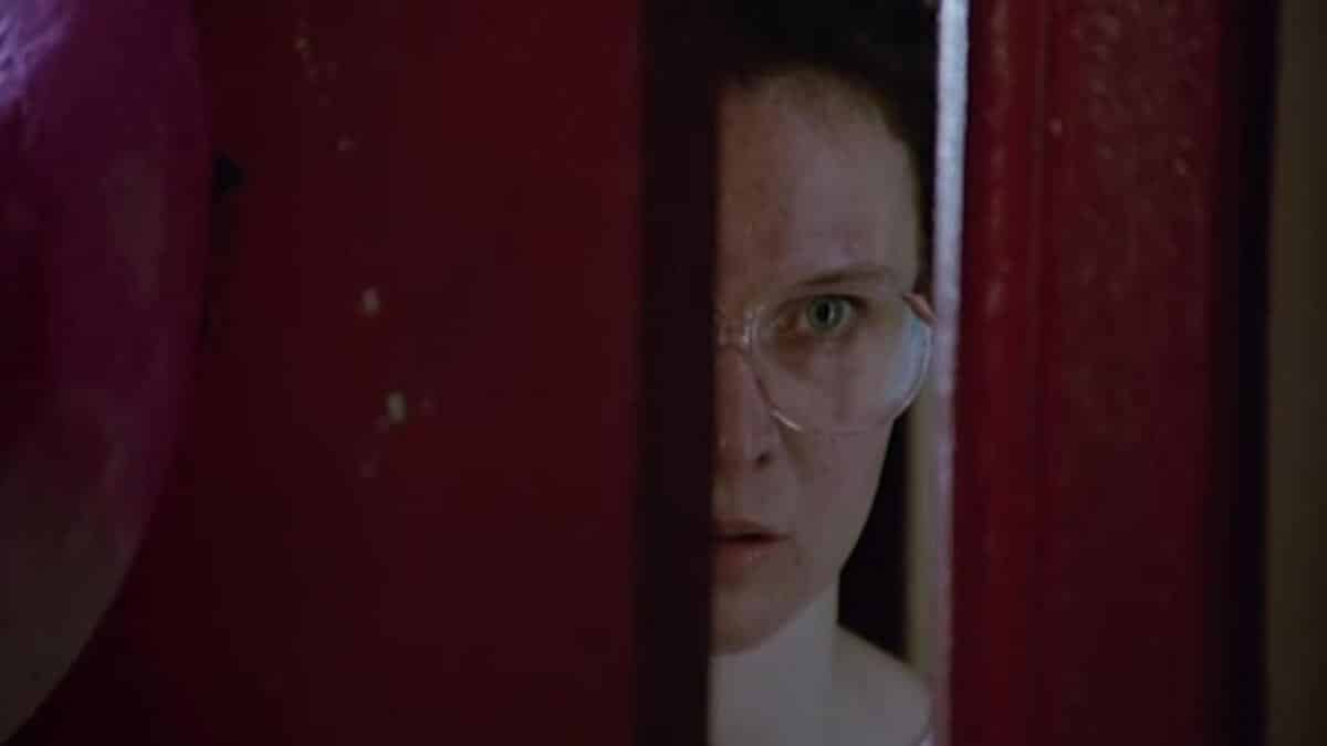 Fran wearing glasses and hiding behind a door in Strictly Ballroom