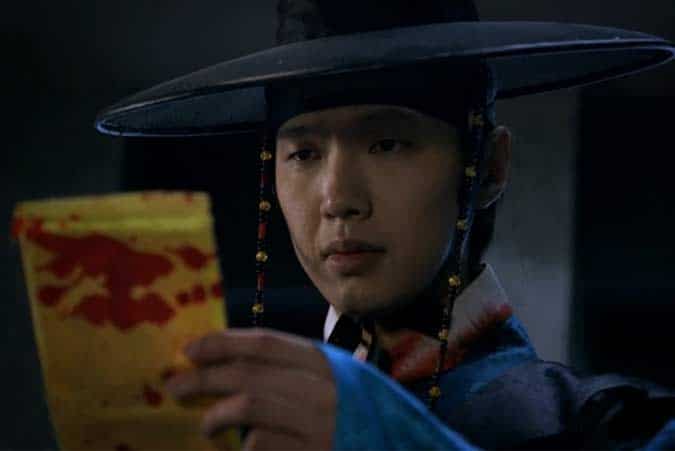 Kim Boong-Do studies the magical protection charm