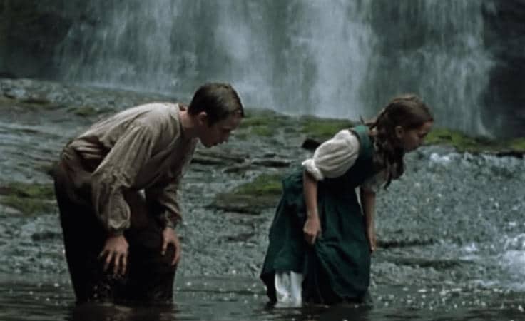 Young John Ridd and young Lorna Doona. John is teaching Lorna how to catch a fish with her hands.