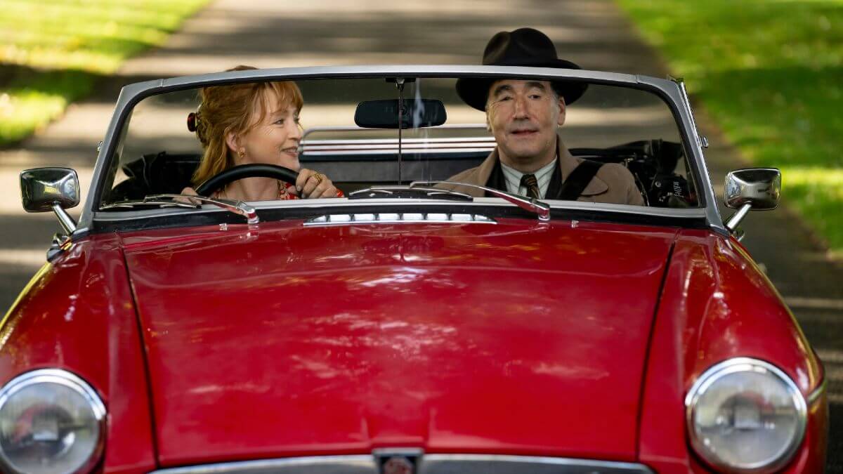 Susan Ryeland and Atticus Pünd in a red car